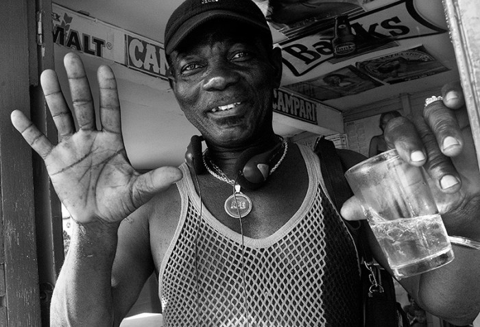 Man drinking rum, Barbados. Photographer Paul Marshall